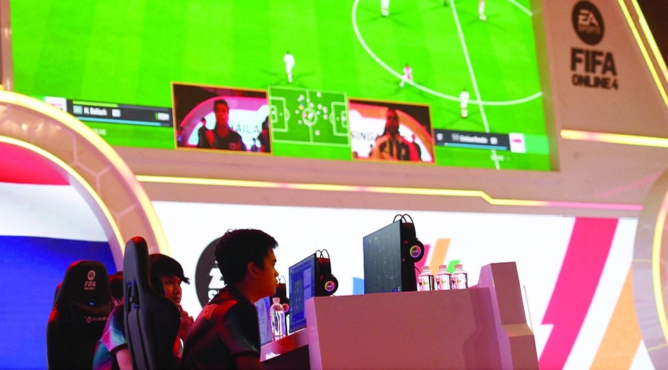 HANOI: The FIFA Online 4 esports team of Thailand (left) competes against Singapore in a football esport game during the 31st Southeast Asian Games (SEA Games) in Hanoi on May 14, 2022. - AFP