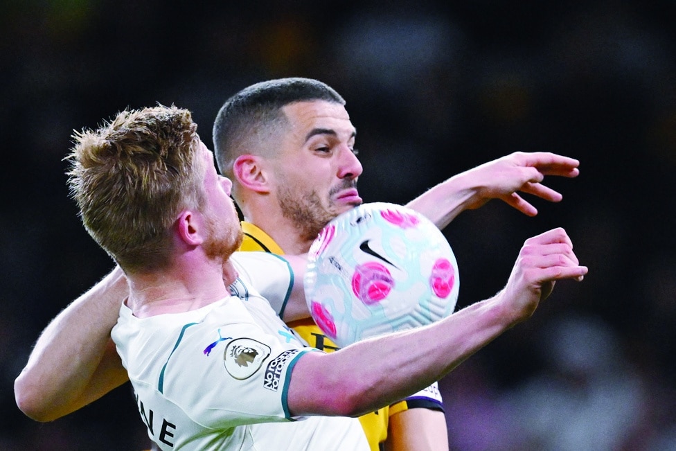 WOLVERHAMPTON: Manchester City's Belgian midfielder Kevin De Bruyne (left) fights for the ball with Wolverhampton Wanderers' English defender Conor Coady during the English Premier League football match at the Molineux stadium in Wolverhampton.- AFP