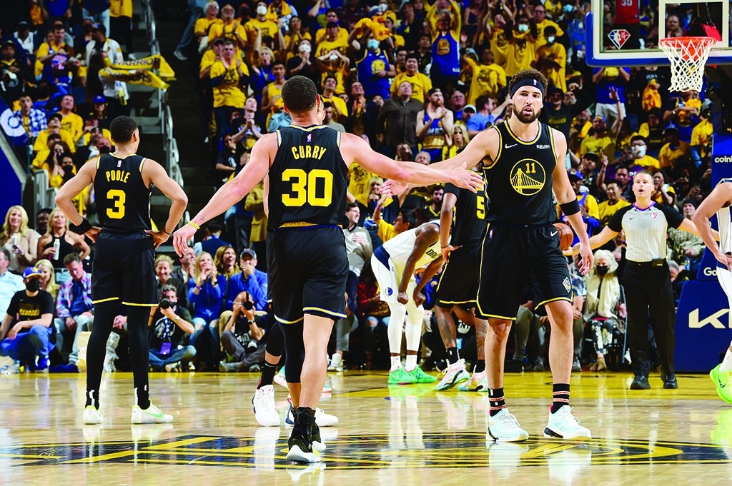 SAN FRANCISCO: Stephen Curry #30 hi-fives Klay Thompson #11 of the Golden State Warriors during Game 1 of the 2022 NBA Playoffs Western Conference Finals on May 18, 2022 at Chase Center in San Francisco, California. - AFP