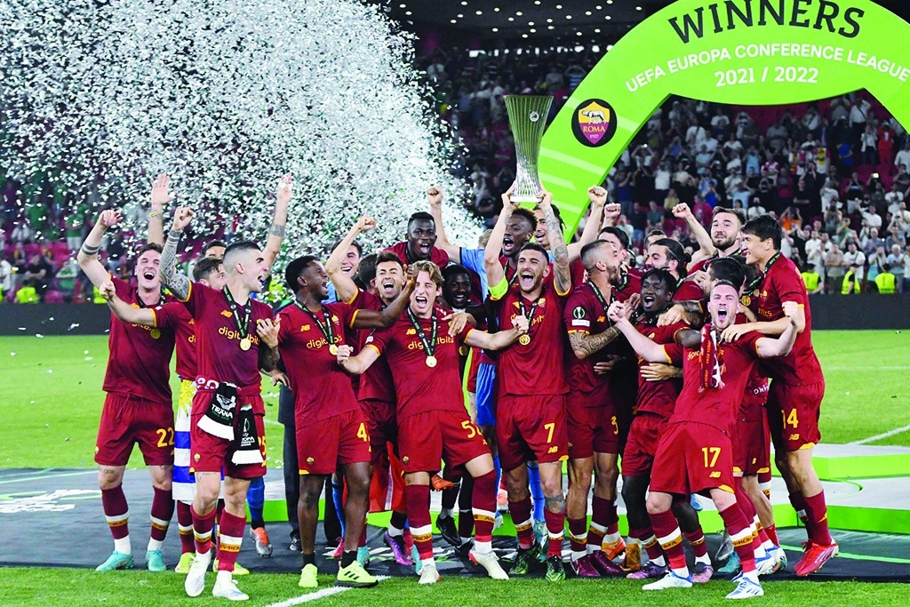 TIRANA: Roma's players celebrate with the trophy after winning the UEFA Europa Conference League final against Feyenoord at the Air Albania Stadium on May 25, 2022. - AFP