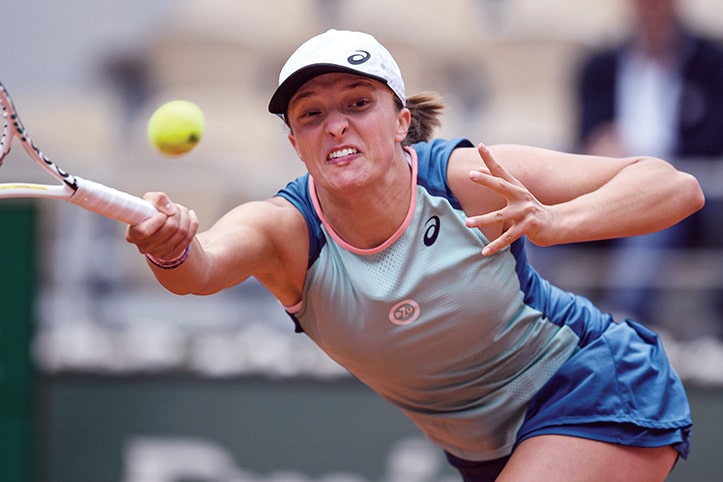 PARIS: Poland’s Iga Swiatek returns to Montenegro’s Danka Kovinic during their women’s singles match on day seven of the Roland-Garros Open tennis tournament at the Court Philippe-Chatrier in Paris on May 28, 2022.  —AFP