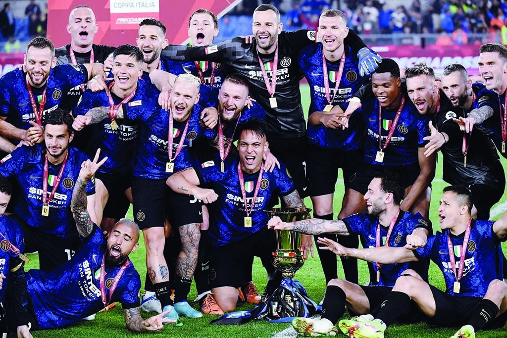 ROME: Inter Milan players celebrate with the trophy after winning the Italian Cup (Coppa Italia) final against Juventus on May 11, 2022 at the Olympic stadium. - AFP
