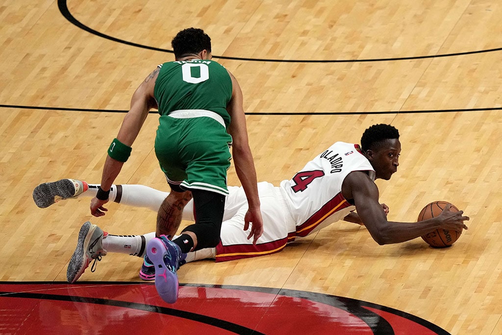 MIAMI: Victor Oladipo #4 of the Miami Heat dives for the ball against Jayson Tatum #0 of the Boston Celtics during the third quarter in Game One of the 2022 NBA Playoffs Eastern Conference Finals at FTX Arena on May 17, 2022.– AFP