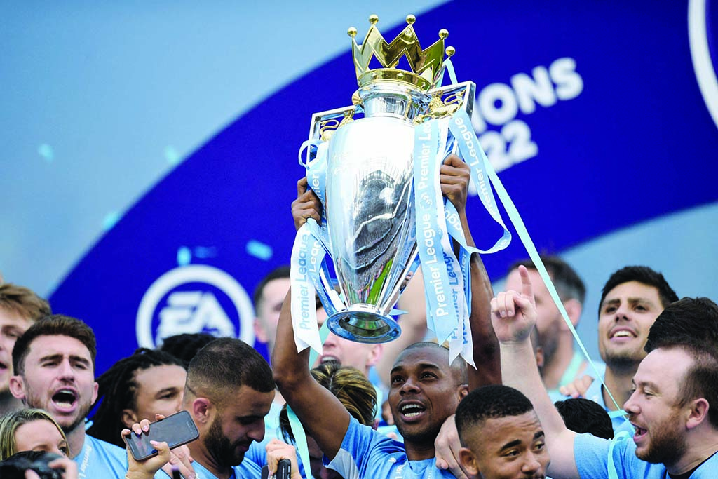 MANCHESTER: Manchester City’s players celebrate with the Premier League trophy during the award ceremony after the English Premier League football match between Manchester City and Aston Villa at the Etihad Stadium in Manchester on May 22, 2022. - AFP