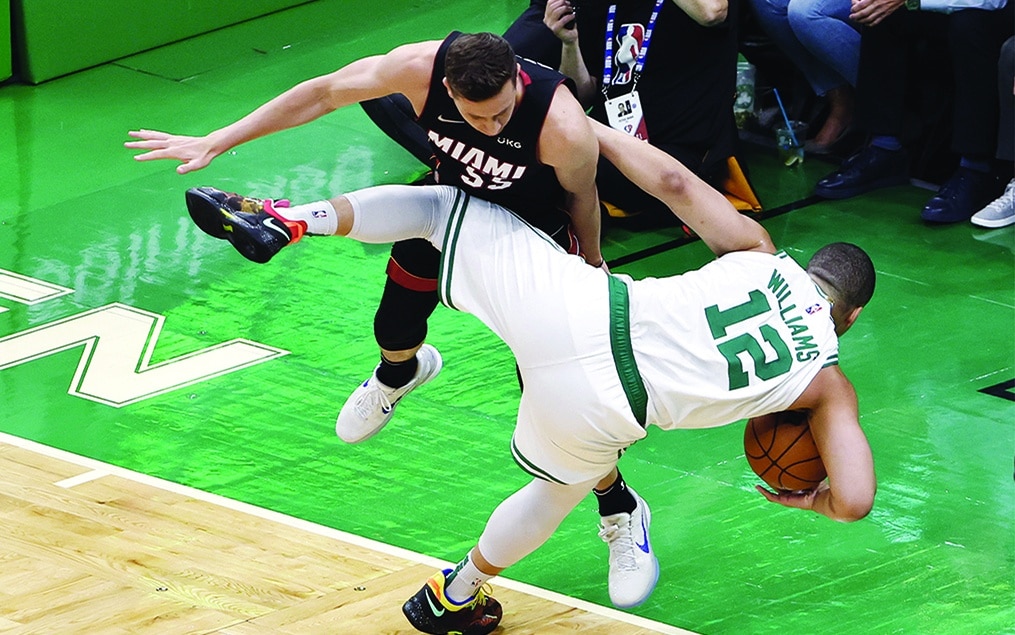 BOSTON: Duncan Robinson #55 of the Miami Heat collides with Grant Williams #12 of the Boston Celtics during the first quarter in Game Four of the 2022 NBA Playoffs Eastern Conference Finals at TD Garden on May 23, 2022. - AFP