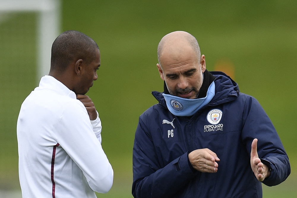 MANCHESTER: Manchester City's Spanish manager Pep Guardiola (right) speak to Manchester City's Brazilian midfielder Fernandinho as they take part in a training session at the Manchester City training ground in Manchester, north west England, on May 3, 2022, on the eve of their UEFA Champions League semi-final second leg football match against Real Madrid. - AFP