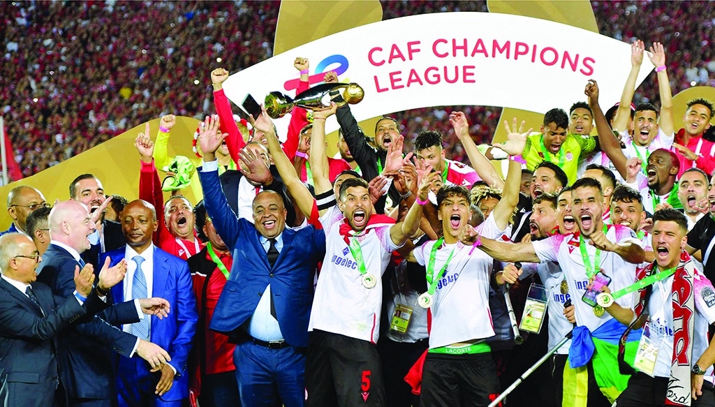 CASABLANCA: Wydad's midfielder Yahya Jabrane (center) lifts the trophy as he celebrates with his teammates after winning the CAF Champions League Semi-Final between Egypt's Al-Ahly and Morocco's Wydad AC on May 30, 2022. - AFP