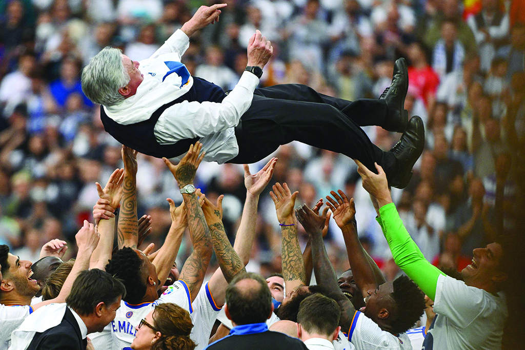 MADRID: Real Madrid's players carry Real Madrid's Italian coach Carlo Ancelotti at the end of the Spanish League football match between Real Madrid and Espanyol at the Santiago Bernabeu stadium on April 30, 2022. - AFP