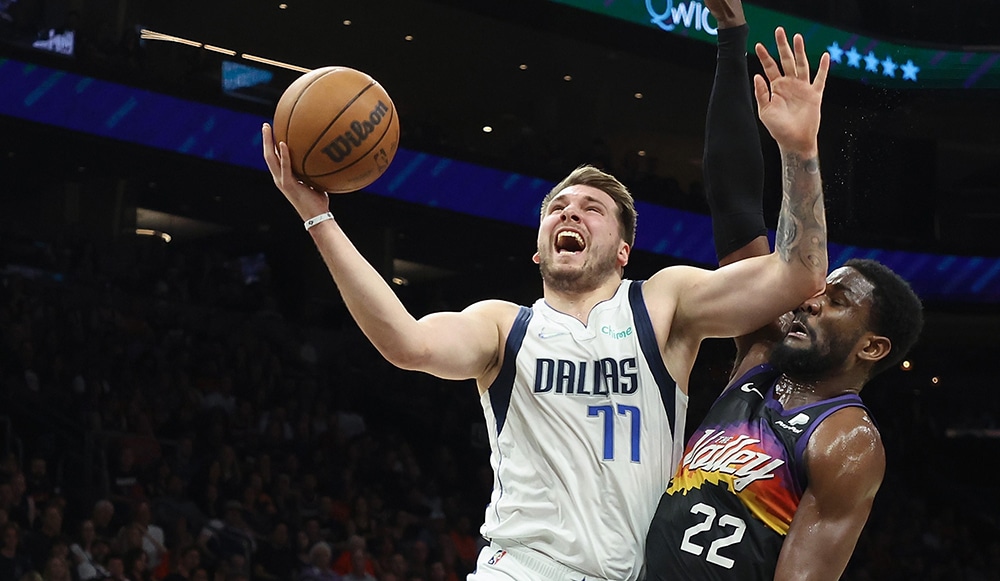 PHOENIX: Luka Doncic #77 of the Dallas Mavericks attempts a shot against Deandre Ayton #22 of the Phoenix Suns during the first half of Game One of the Western Conference Second Round NBA Playoffs at Footprint Center on May 02, 2022 in Phoenix, Arizona. - AFP