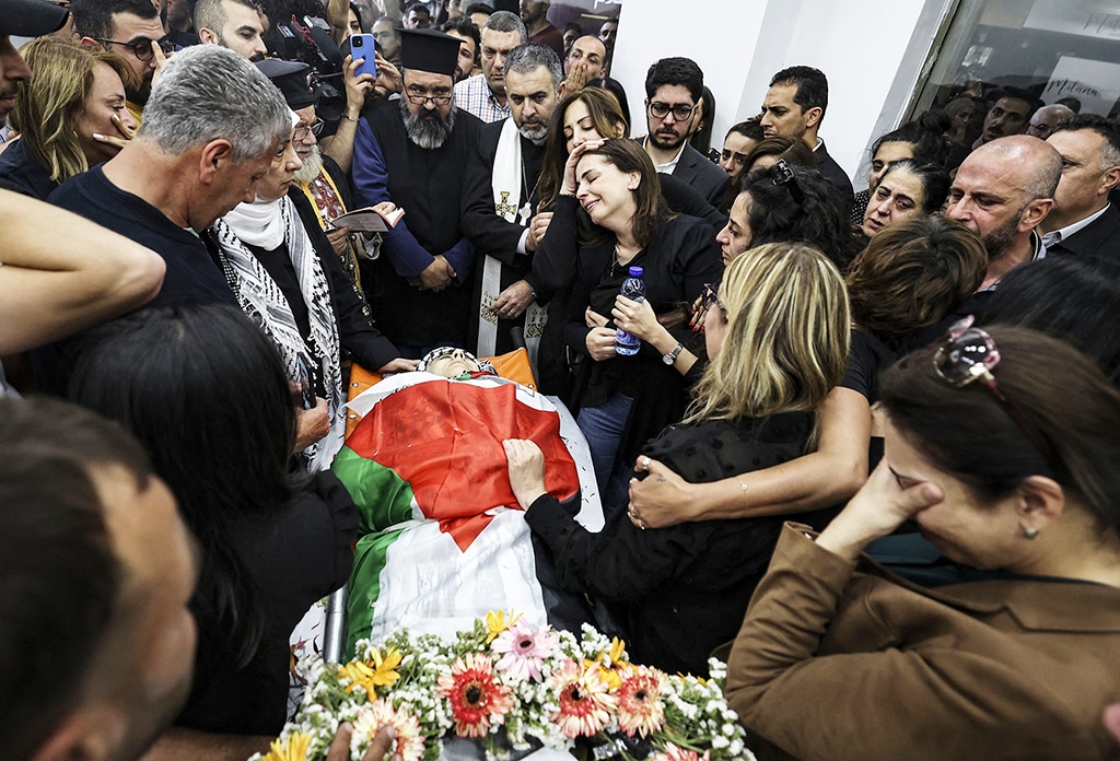 Colleagues and friends react as the body of Abu Akleh is brought to the offices of the news channel in the West Bank city of Ramallah on May 11, 2022.