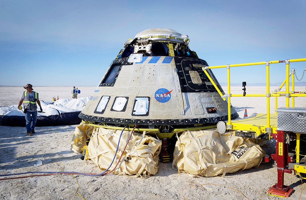 WHITE SANDS, New Mexico: Boeing and NASA teams work around Boeing's CST-100 Starliner spacecraft after it landed at White Sands Missile Range's Space Harbor on May 25, 2022. - AFP