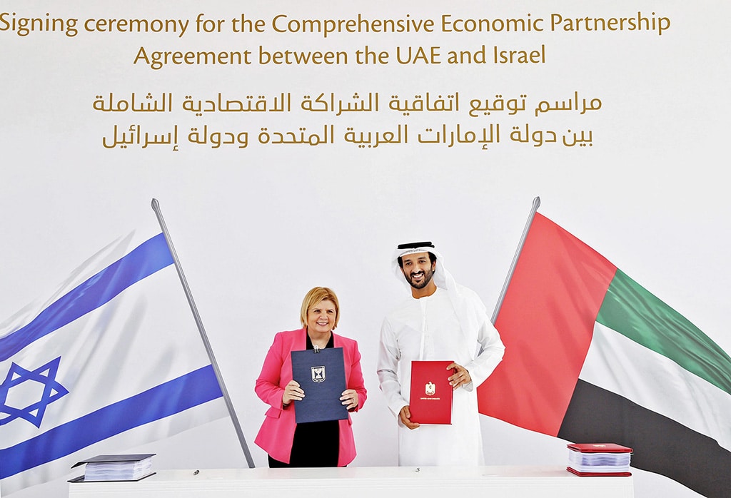 DUBAI: The economy ministers of the Zionist entity and the UAE, Orna Barbivai and Abdulla bin Touq Al-Marri, pose for a photo during a signing ceremony for a free trade deal on May 31, 2022. - AFP