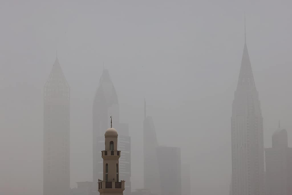 DUBAI: This picture taken on May 18, 2022 shows a view of the haze obscuring the skyline with a mosque in the foreground during a heavy sandstorm. - AFP