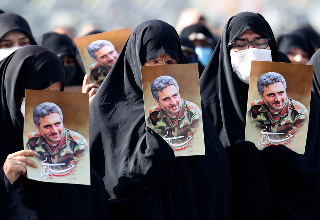 TEHRAN: Iranian women lift portraits of Revolutionary Guards colonel Sayyad Khodai during his funeral procession at Imam Hussein Square on May 24, 2022. – AFP