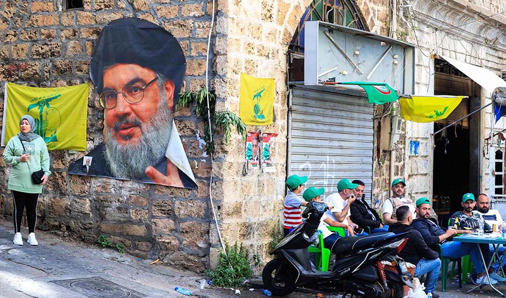 BEIRUT: Electoral delegates for Lebanon's Shiite groups Amal (left) and Hezbollah sit in front of a polling station during Lebanon's parliamentary elections in Beirut.- AFP
