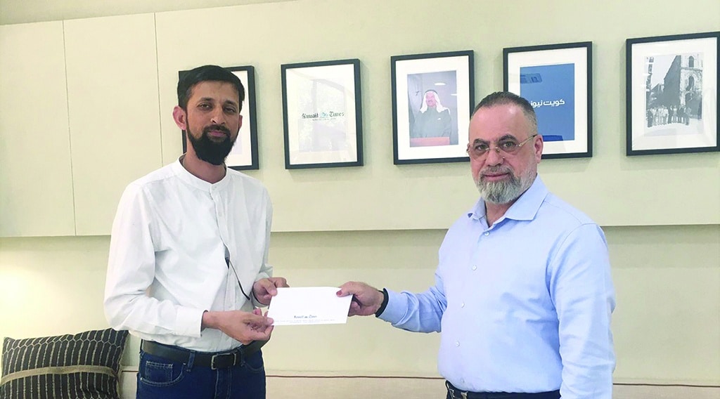 KUWAIT: Ismail Fakruddin receives the award from Kuwait Times Advertising Manager Department Taleb Kanjo.
