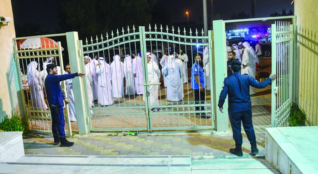KUWAIT: Police officers close a polling station at the conclusion of voting for the Municipal Council elections. - KUNA photos