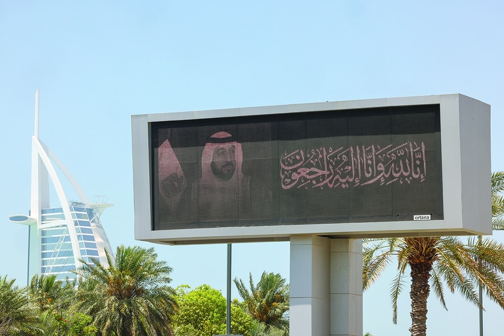 A billboard displays the portrait of late UAE's President Sheikh Khalifa bin Zayed Al-Nahyan in the Emirate of Dubai on May 14, 2022, as the oil-rich Gulf state observes a period of mourning. - Khalifa bin Zayed Al-Nahyan died on May 13, aged 73 after a years-long battle with illness, triggering a period of mourning and a handover of power in the oil-rich Gulf state. The UAE's long-time de facto ruler Sheikh Mohamed bin Zayed Al Nahyan was elected as president, official media said, a day after the death of former leader Sheikh Khalifa. (Photo by Giuseppe CACACE / AFP)