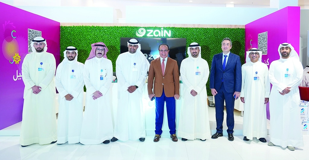 KUWAIT: Fahad Al-Othman with Zain officials at the company's booth.