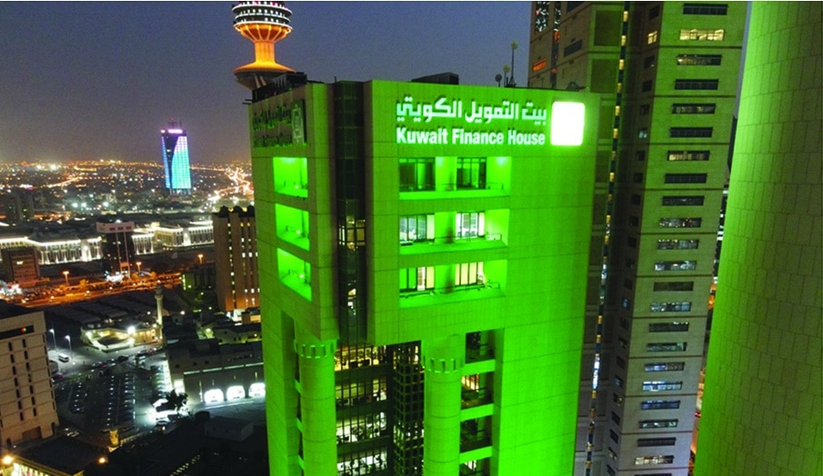 The KFH Headquarters building lit in green.