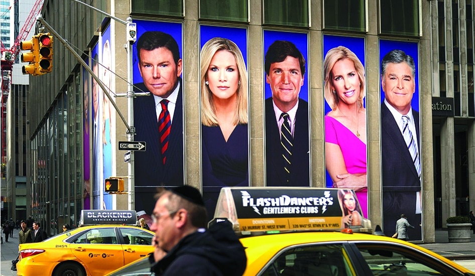 NEW YORK: File photo shows Fox News personalities, including Bret Baier, Martha MacCallum, Tucker Carlson, Laura Ingraham, and Sean Hannity, adorn the front of the News Corporation building, in New York City. – AFP