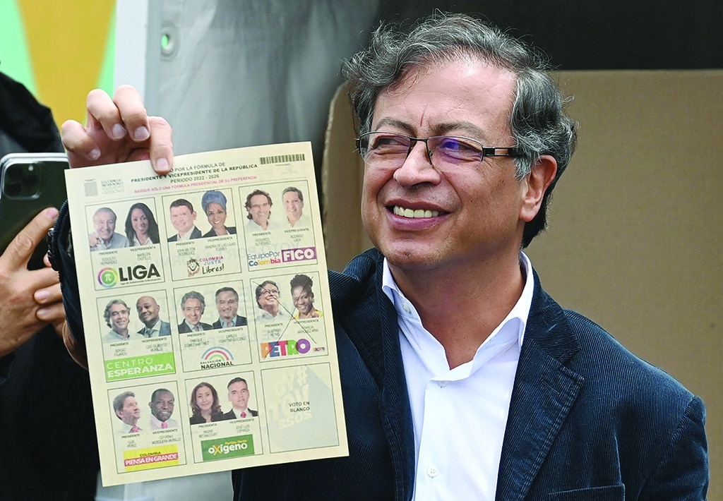 BOGOTA: Colombian presidential candidate for the Historic Pact coalition, Gustavo Petro, shows his ballot as he votes during the presidential election on May 29, 2022. - AFP