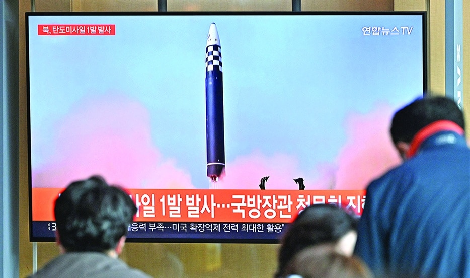 SEOUL: File picture shows people watching a television screen showing a news broadcast with file footage of a North Korean missile test, at a railway station in Seoul. – AFP