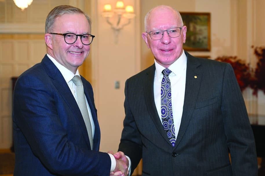CANBERRA: Australia's new Prime Minister Anthony Albanese (L) shakes hands with Australia's Governor General David Hurley (R) after taking an oath at Government House in Canberra on May 23, 2022. - AFP
