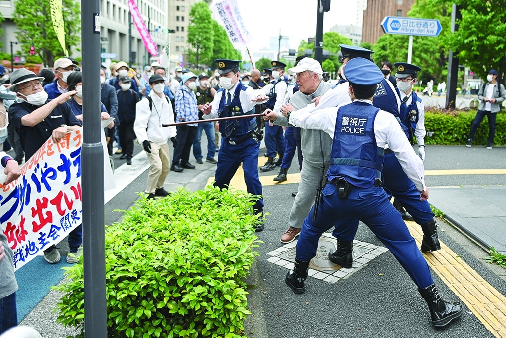 TOKYO, Japan: A counter-protester (2nd R) confronts anti-US military base protesters (not pictured) take part in a march to mark the 50th anniversary of the US return of Okinawa to Japan, in Tokyo on May 15, 2022. - AFP