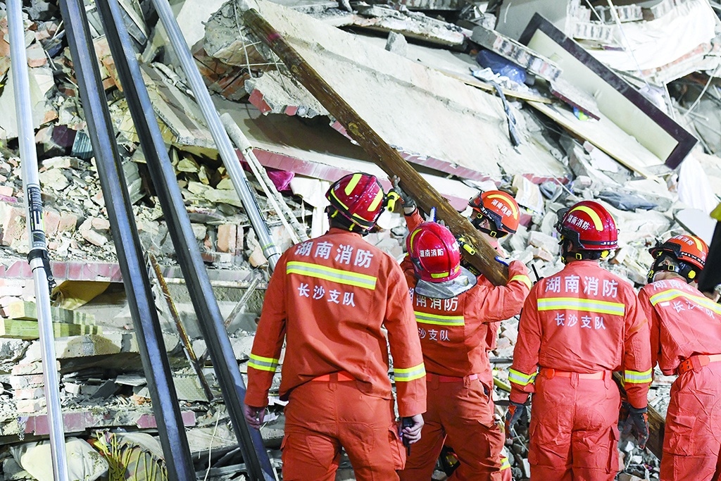 This photo taken on April 29, 2022 shows rescuers searching for survivors at a collapsed six-storey building in Changsha, central Chinaís Hunan province. - Dozens of people were trapped under a building which collapsed in central China, officials said on April 30, as rescuers clawed through the rubble and used buzzsaws to pull several survivors free. (Photo by - / CNS / AFP) / China OUT / CHINA OUT