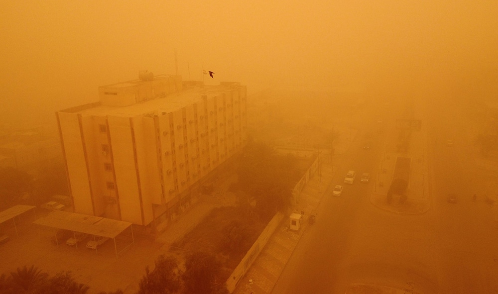 Nasiriyah: An aerial picture shows a view of Iraq's southern city of Nasiriyah during a heavy sandstorm on May 5, 2022. Iraq is yet again covered in a thick sheet of orange as it suffers the latest in a series of dust storms that have become increasingly common. Iraq was hammered by a series of such storms in April, grounding flights and leaving dozens hospitalised with respiratory problems.— AFP