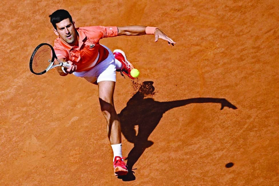 ROME: Serbia's Novak Djokovic returns to Russia's Aslan Karatsev during their first round match at the ATP Rome Open tennis tournament on May 10, 2022. - AFP
