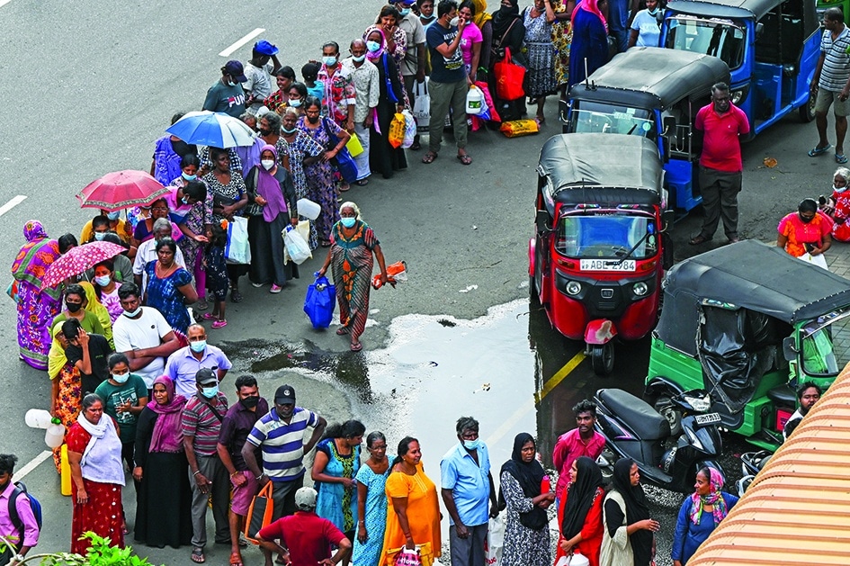 COLOMBO: People queue up to buy kerosene for domestic use at a supply station in Colombo. – AFP