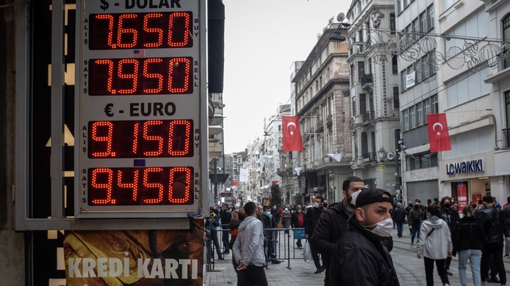 ISTANBUL: People walk past a currency exchange board in Istanbul.