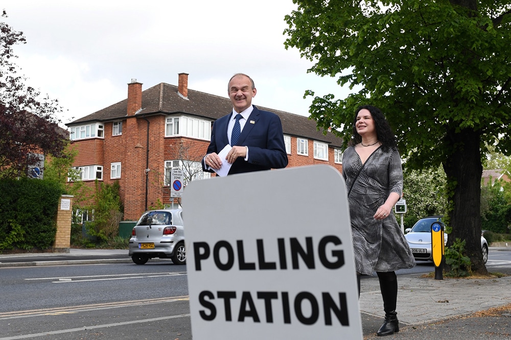 LONDON: Britain's Liberal Democrat leader Ed Davey (L) arrives at a polling station, in Surbiton, South West London, to cast his vote in local elections, on May 5, 2022. Polls opened across the UK in local and regional elections that could prove historic in Northern Ireland and heap further pressure on embattled Prime Minister Boris Johnson.