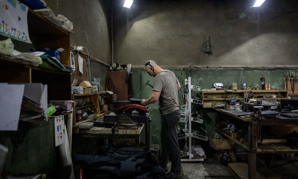 Zaporizhzhia, Ukraine: Andrii Paliy prepares materials that he uses to produce bullet-proof armour plates, at his workshop in Zaporizhzhia on May 1, 2022. Before Russia's invasion of Ukraine, medieval combat enthusiasts and self-taught blacksmiths Vadim Mernichenko and Andrii Paliy used their workshop and skills to turn out suits of amour and swords, but these days the duo have their minds elsewhere - bulletproof protection for the Ukrainian army.  --AFP