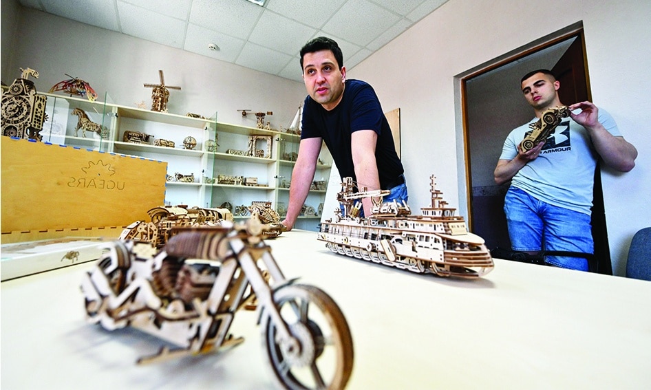 Ugears CEO, Oleksiy Lysianyi (left), presents models in an office at the facilities of wooden models manufacturing company Ugears, in Gorenka village, north of the Ukrainian capital Kyiv. — AFP photos