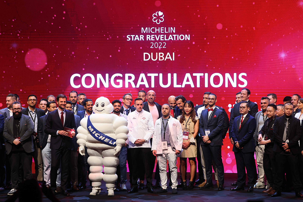 Chefs and owners pose for a picture on the stage during a ceremony revealing the 2022 selection of the Michelin Guide Dubai, the first-ever edition in the United Arab Emirates. — AFP photos
