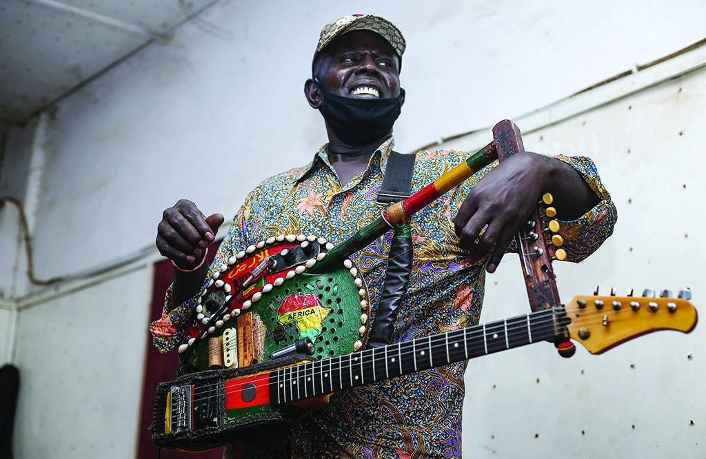 Noureddine Jaber plays a song during rehearsals at a studio in Omdurman, the capital Khartoum's twin city.-AFP photos