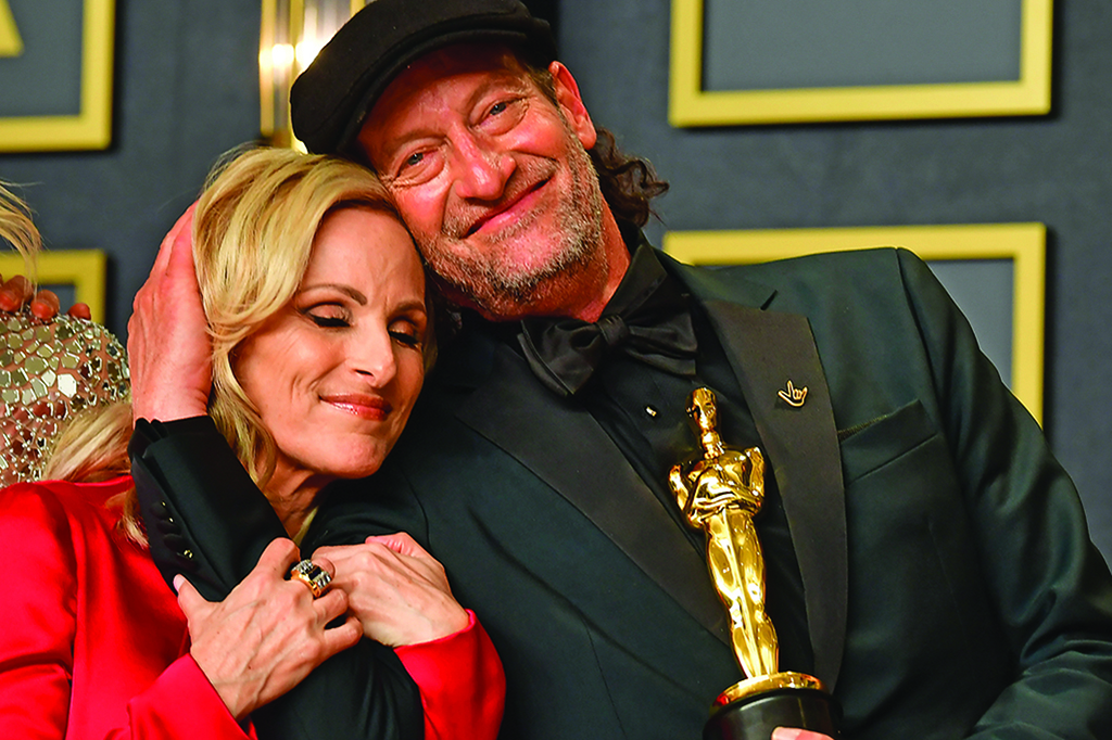 In this file photo US actress Marlee Matlin (left) and US actor Troy Kotsur embrace as the cast of CODA, winner of Best Picture, gathers in the press room during the 94th Oscars at the Dolby Theatre in Hollywood, California. — AFP