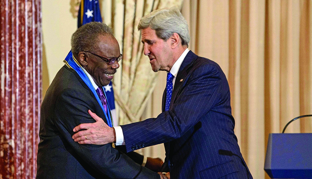 In this file photo US Secretary of State John Kerry congratulates US artist Sam Gilliam during an Art in Embassies Medal of Arts Award event at the US Department of State in Washington, DC.—AFP photos