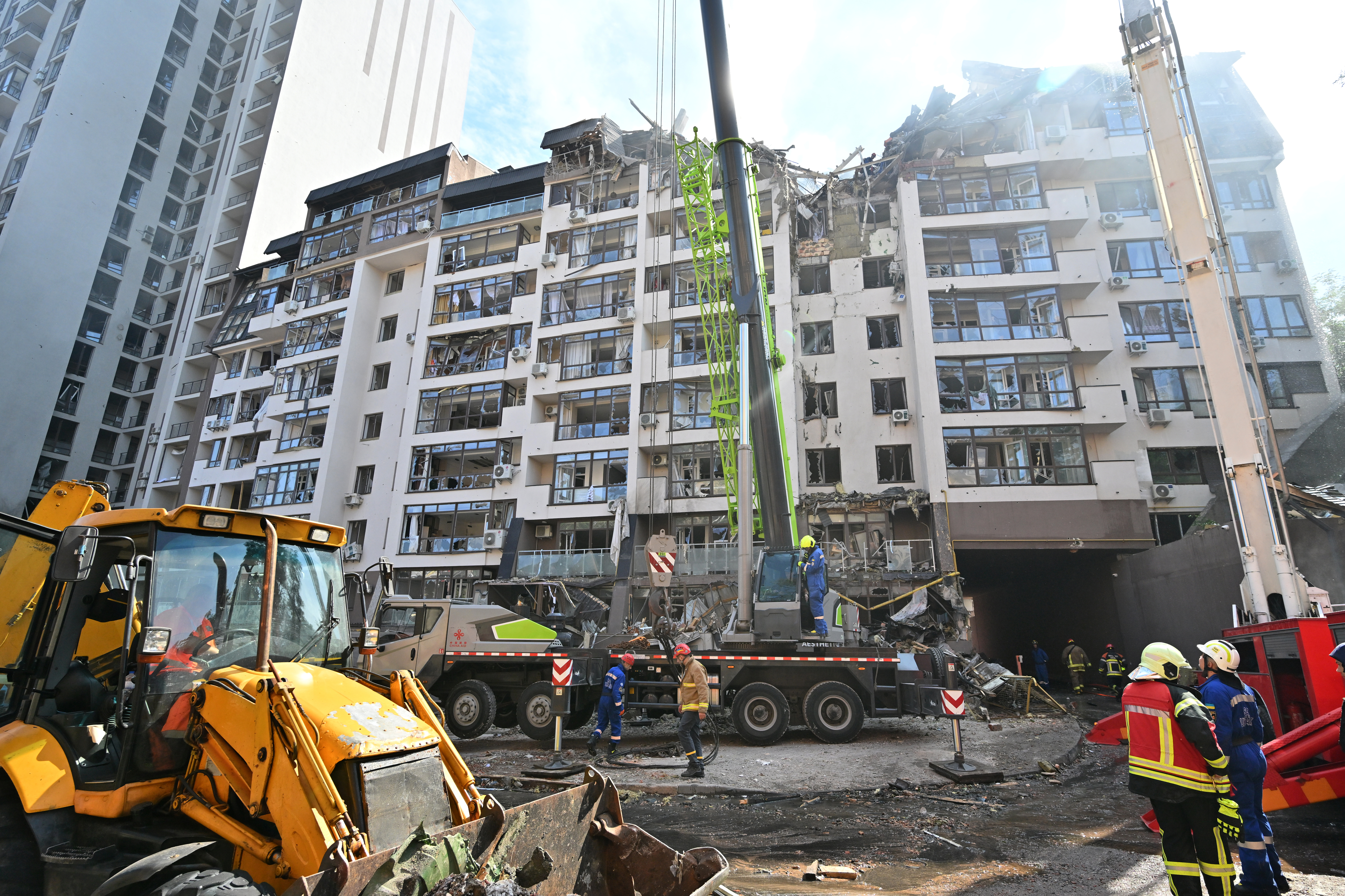 Ukrainian rescuers work outside a residential building hit by Russian missiles in Kyiv on June 26, 2022, amid Russian invasion of Ukraine. - AFP