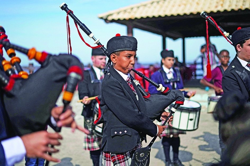 Bagpipe students, members of the Vieira Brum music band, play at the Marica beach, in Marica, Rio de Janeiro state, on May 28, 2022. – AFP photos