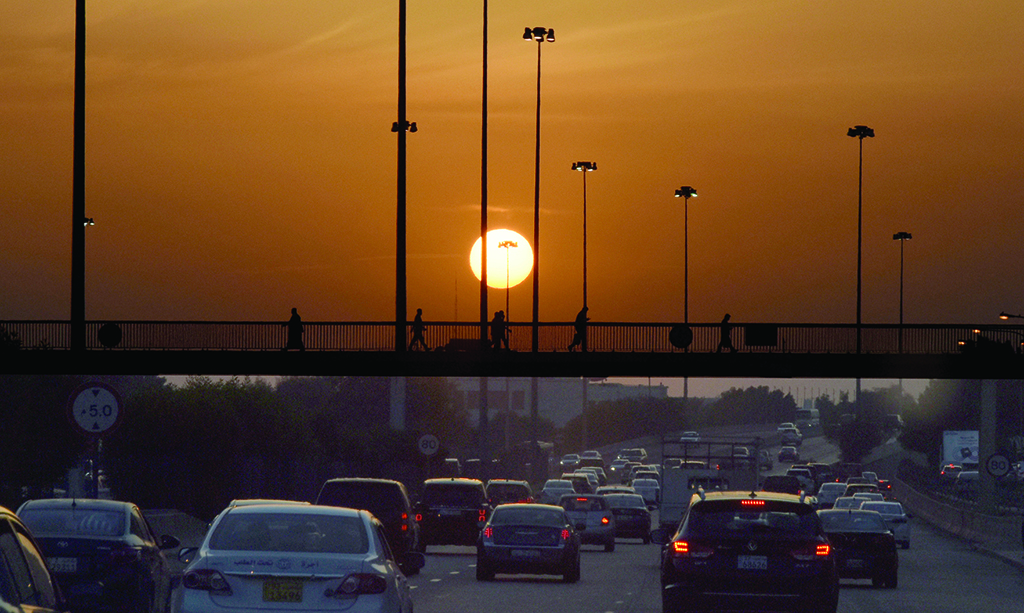 KUWAIT: Vehicles drive on a main highway in Kuwait at sunset. - Photo by Fouad Al-Shaikh