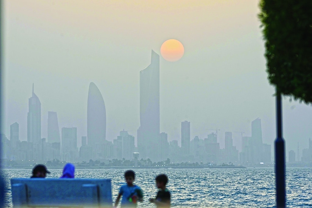 KUWAIT: People relax at a beach during sunset in Kuwait City, Kuwait. - Xinhua