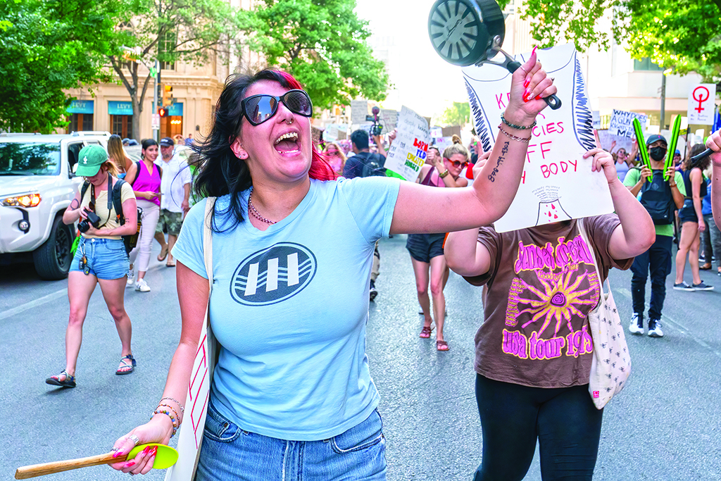 AUSTIN: An abortion rights demonstrator holding a pan chants slogans as they march near the State Capitol in Austin, Texas. Abortion rights defenders fanned out across America on June 25 for a second day of protest against the Supreme Court's thunderbolt ruling. - AFP