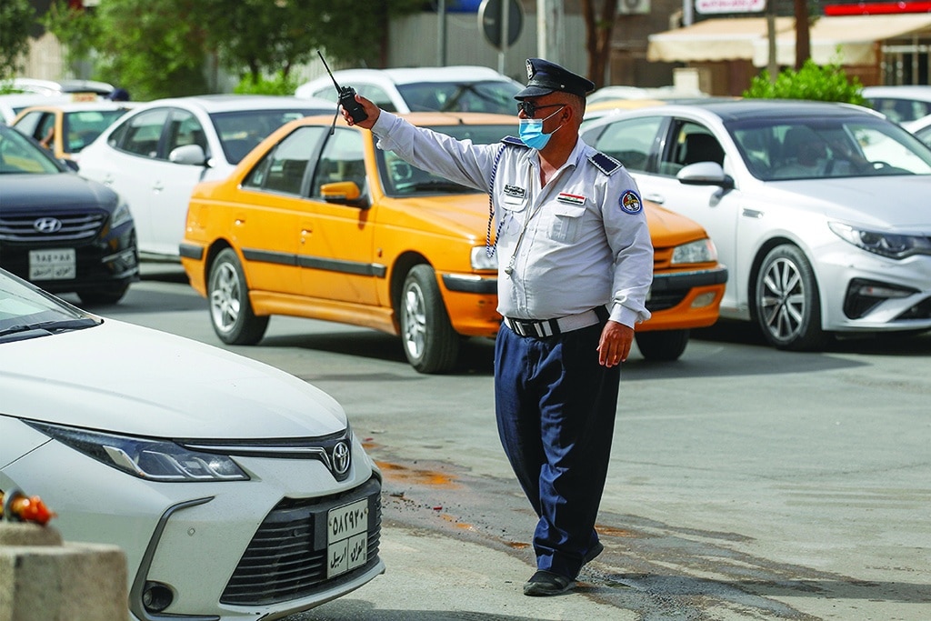 BAGHDAD: An Iraqi policeman directs traffic in the streets of the capital on May 31, 2022. - AFP