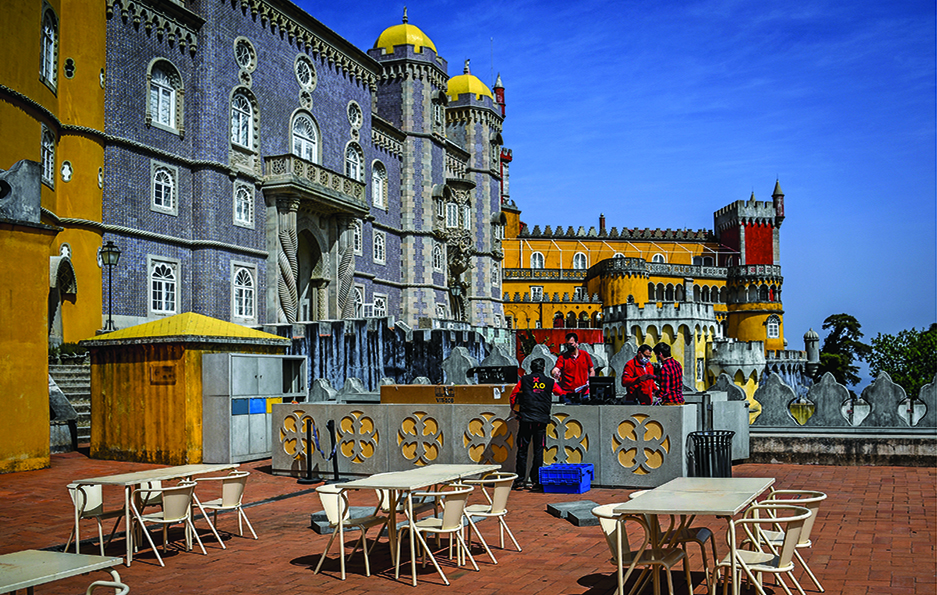 SINTRA: Technicians work at the esplanade of the Pena Palace in Sintra. Hard-hit Portugal has gradually eased a general lockdown.- AFP