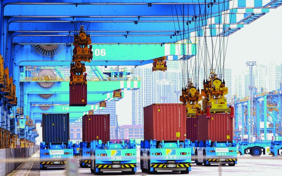 QINGDAO, China: Cranes load containers onto trucks at a port in Qingdao, in China's eastern Shandong province on June 9, 2022. – AFP
