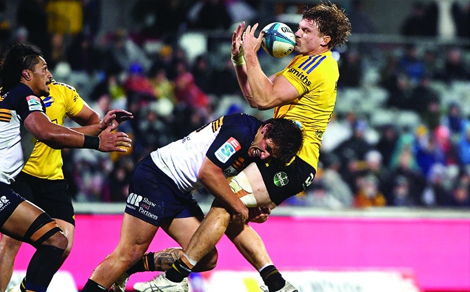 CANBERRA: Hurricanes’ Blake Gibson is tackled by Brumbies’ Ollie Sapsford (center) during the Super Rugby Pacific quarterfinal match between the Australia’s Brumbies and New Zealand’s Hurricanes at GIO Stadium in Canberra on June 4, 2022. - AFP